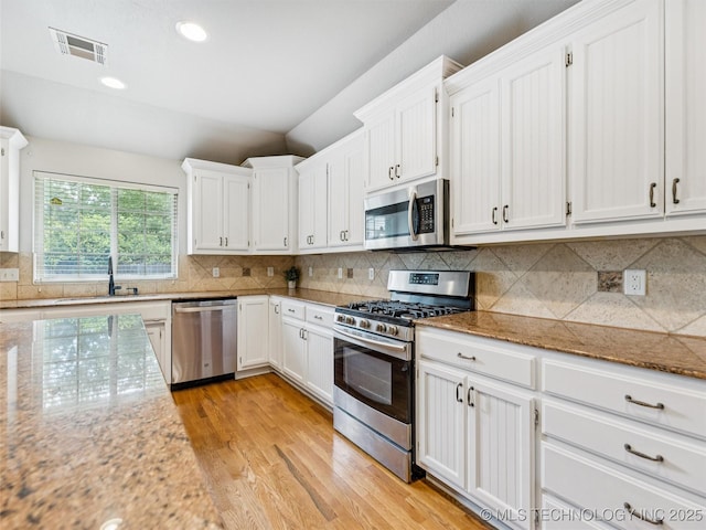 2505 S Willow Ave, Broken Arrow, OK 74012 - kitchen featuring appliances with stainless steel finishes, light wood-style flooring, a sink, white cabinetry, and recessed lighting