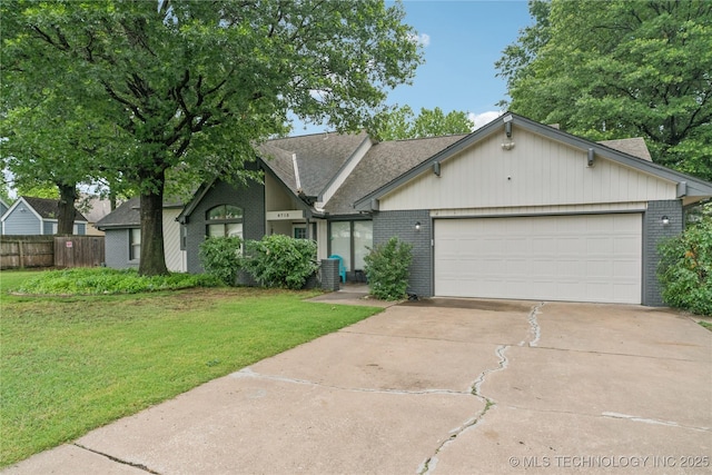 8713 S 77th E Ave, Tulsa, OK 74133 - view of front of property featuring brick siding, driveway, an attached garage, and a shingled roof