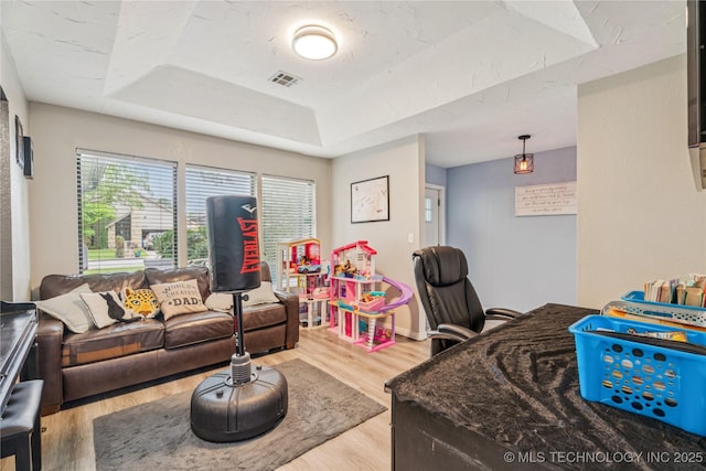 8713 S 77th E Ave, Tulsa, OK 74133 - living area featuring a raised ceiling, wood finished floors, and baseboards