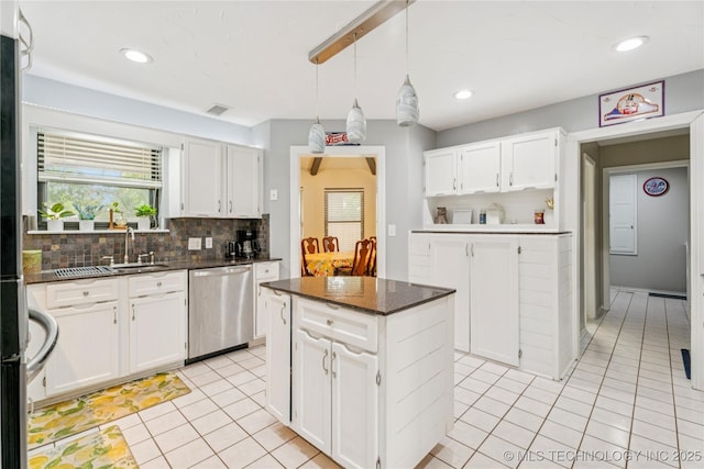 8713 S 77th E Ave, Tulsa, OK 74133 - kitchen with dishwasher, light tile patterned floors, decorative backsplash, a sink, and white cabinets