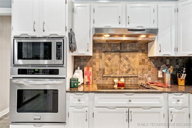 8713 S 77th E Ave, Tulsa, OK 74133 - kitchen with appliances with stainless steel finishes, extractor fan, white cabinets, decorative backsplash, and dark stone countertops