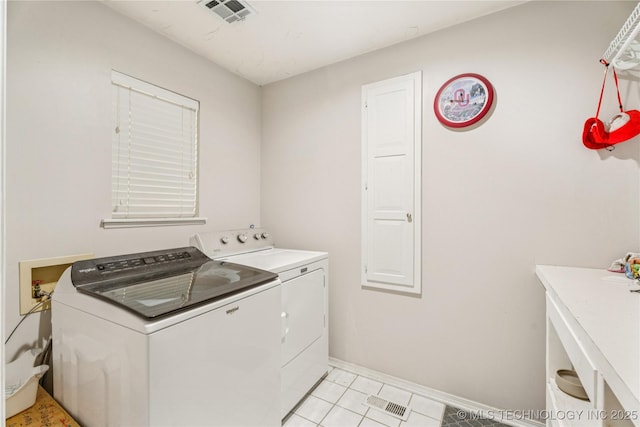 8713 S 77th E Ave, Tulsa, OK 74133 - laundry area with washing machine and clothes dryer, light tile patterned floors, and baseboards