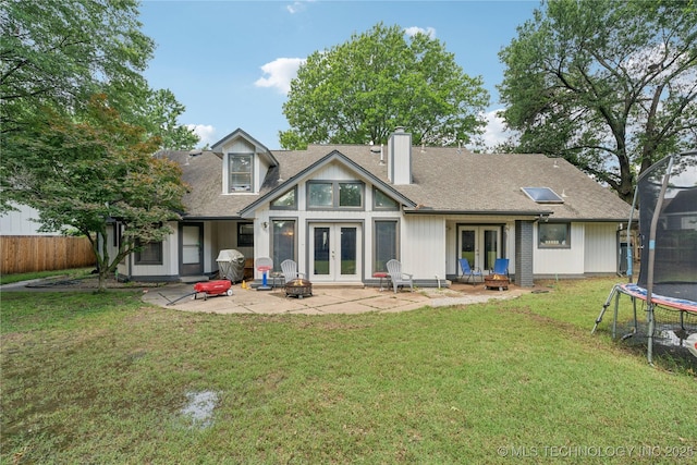 8713 S 77th E Ave, Tulsa, OK 74133 - rear view of property with french doors, a trampoline, a patio area, a chimney, and an outdoor fire pit