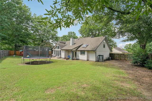 8713 S 77th E Ave, Tulsa, OK 74133 - rear view of property with a trampoline and central air condition unit