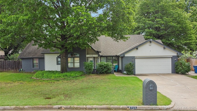 8713 S 77th E Ave, Tulsa, OK 74133 - view of front of home with an attached garage, concrete driveway, brick siding, and a shingled roof