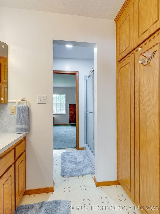 121 W 17th St, Ada, OK 74820 - full bath with a shower with shower door, baseboards, and vanity