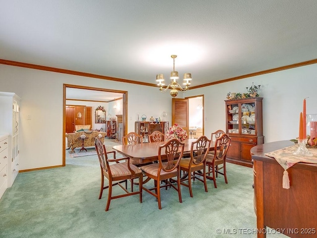 121 W 17th St, Ada, OK 74820 - dining room featuring light colored carpet, a chandelier, ornamental molding, and baseboards