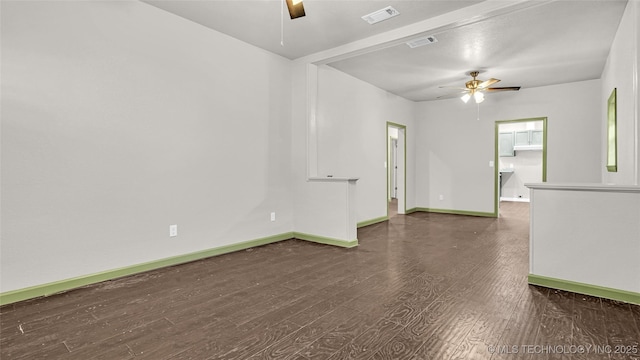 613 NW A St, Ardmore, OK 73401 - unfurnished room featuring a ceiling fan, baseboards, and wood finished floors