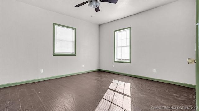 613 NW A St, Ardmore, OK 73401 - spare room with a ceiling fan, wood finished floors, and baseboards