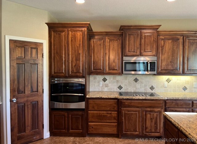 7400 E Prairie View Rd E, Kenefic, OK 74748 - kitchen featuring stainless steel appliances, decorative backsplash, and light stone countertops