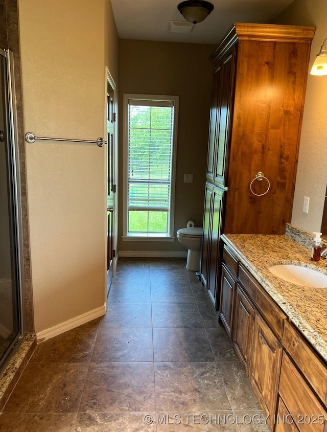 7400 E Prairie View Rd E, Kenefic, OK 74748 - bathroom with toilet, vanity, a shower stall, and baseboards