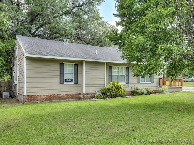 5504 E 5th Pl, Tulsa, OK 74112 - single story home with a front yard, roof with shingles, and central air condition unit