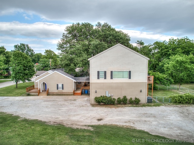 5504 E 5th Pl, Tulsa, OK 74112 - view of front of property featuring a wooden deck and view of scattered trees