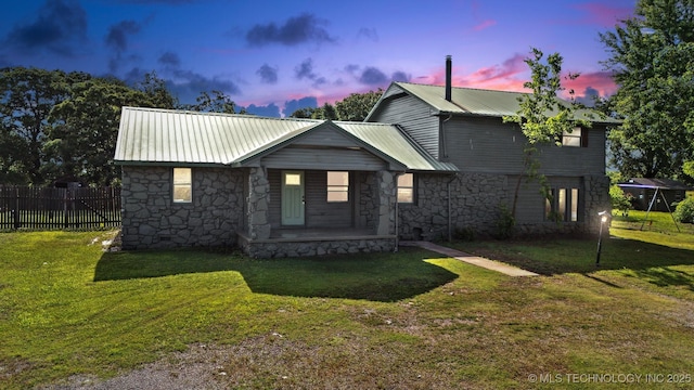 5963 S Westwood Ave, Oilton, OK 74052 - view of front facade with stone siding, metal roof, and covered porch