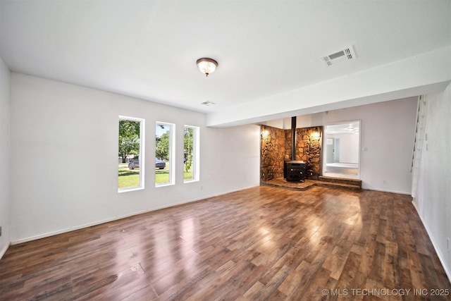 5963 S Westwood Ave, Oilton, OK 74052 - unfurnished living room with a wood stove and wood finished floors