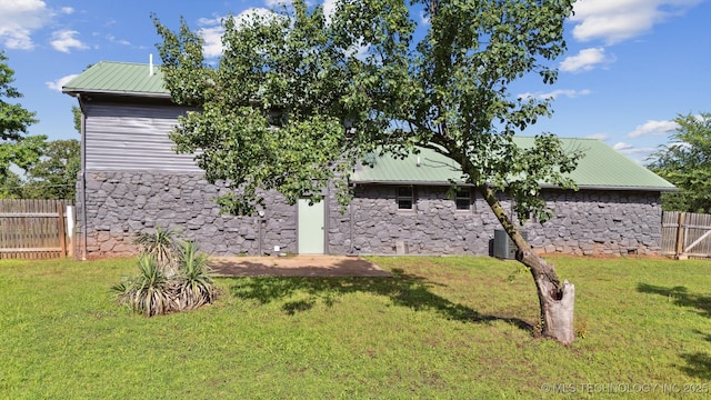 5963 S Westwood Ave, Oilton, OK 74052 - view of property exterior featuring stone siding and metal roof
