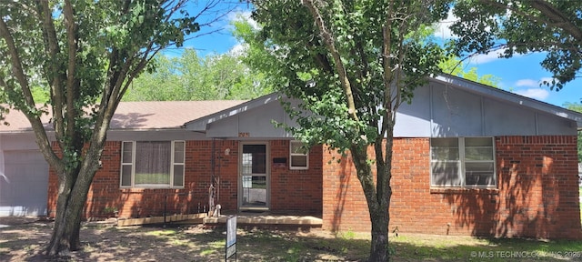 205 N Ash St, Bristow, OK 74010 - view of front of home featuring brick siding and an attached garage