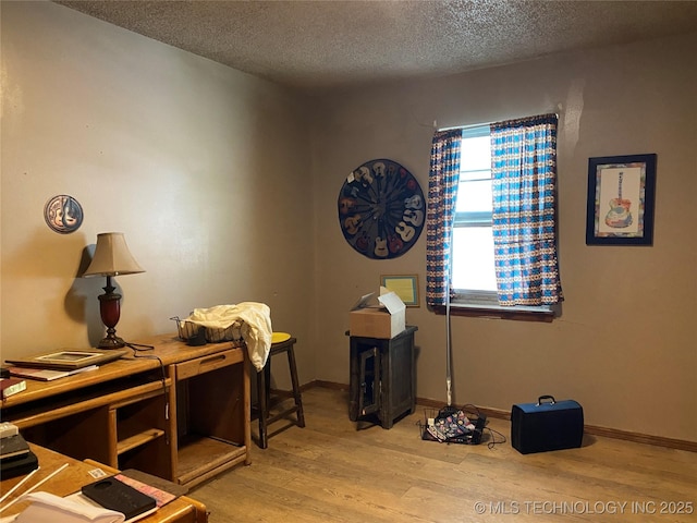 205 N Ash St, Bristow, OK 74010 - home office with light wood-style flooring, a textured ceiling, and baseboards