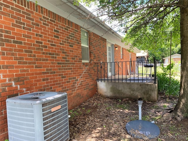 205 N Ash St, Bristow, OK 74010 - view of property exterior with cooling unit and brick siding