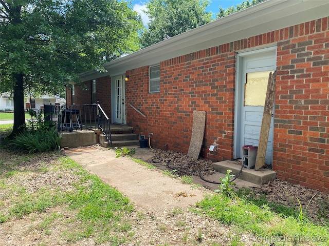 205 N Ash St, Bristow, OK 74010 - view of exterior entry featuring brick siding