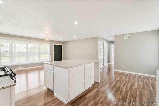 507 S Oklahoma Ave, Haskell, OK 74436 - kitchen featuring stainless steel range, light wood finished floors, recessed lighting, white cabinets, and a kitchen island