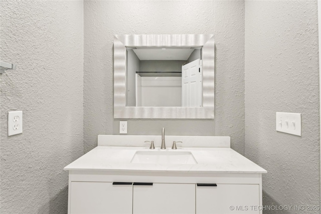 507 S Oklahoma Ave, Haskell, OK 74436 - bathroom featuring a textured wall and vanity