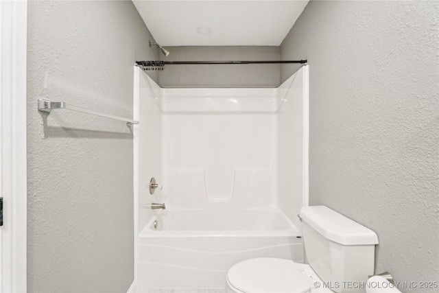 507 S Oklahoma Ave, Haskell, OK 74436 - bathroom with toilet, tub / shower combination, and a textured wall