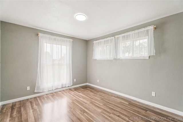 507 S Oklahoma Ave, Haskell, OK 74436 - spare room featuring wood finished floors and baseboards