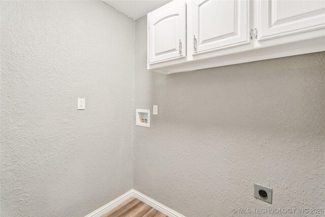 507 S Oklahoma Ave, Haskell, OK 74436 - washroom featuring cabinet space, baseboards, hookup for an electric dryer, washer hookup, and light wood-type flooring