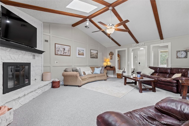 200 Turkey Creek Rd, Bartlesville, OK 74006 - living area featuring carpet flooring, beamed ceiling, a ceiling fan, a decorative wall, and a fireplace
