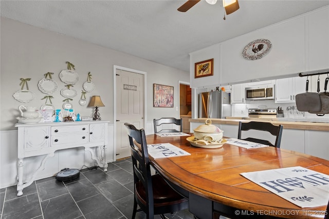 200 Turkey Creek Rd, Bartlesville, OK 74006 - dining space featuring ceiling fan and dark tile patterned floors