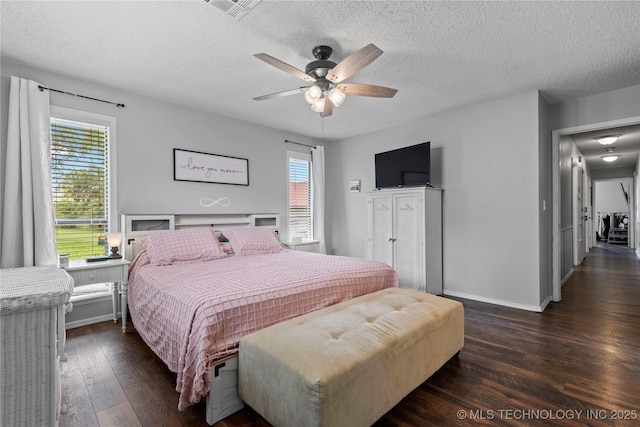 200 Turkey Creek Rd, Bartlesville, OK 74006 - bedroom featuring multiple windows, dark wood finished floors, a textured ceiling, baseboards, and a ceiling fan