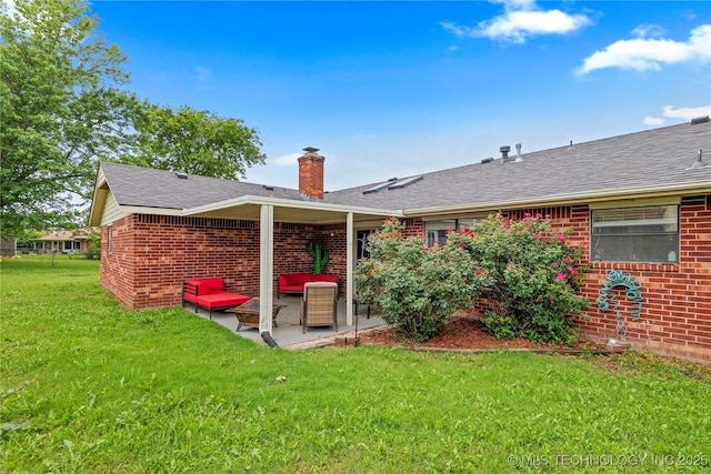 200 Turkey Creek Rd, Bartlesville, OK 74006 - back of house with brick siding, a patio, a yard, and a shingled roof