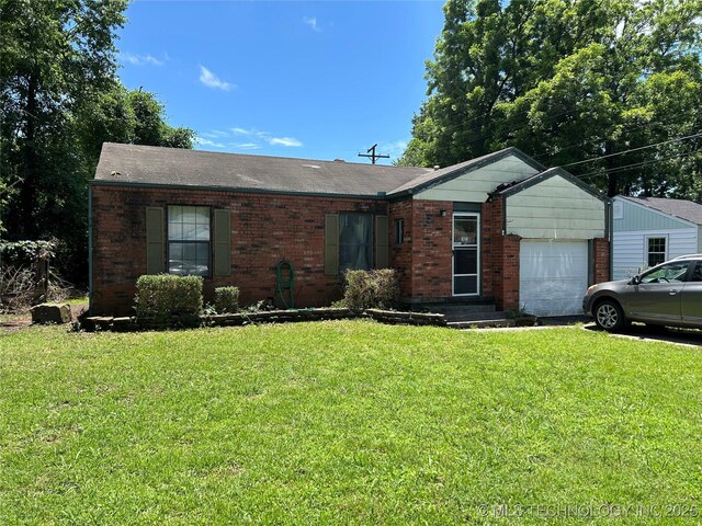 1621 Center Ln, Muskogee, OK 74403 - ranch-style house with a garage, brick siding, a front yard, and roof with shingles