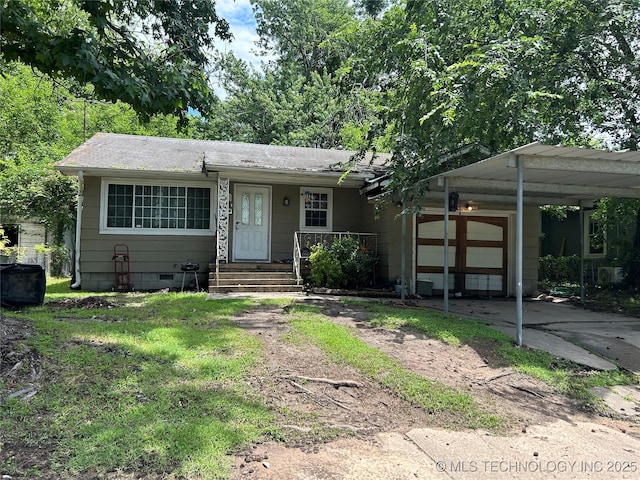 1224 N F St, Muskogee, OK 74403 - view of front of home with a garage, driveway, and covered porch