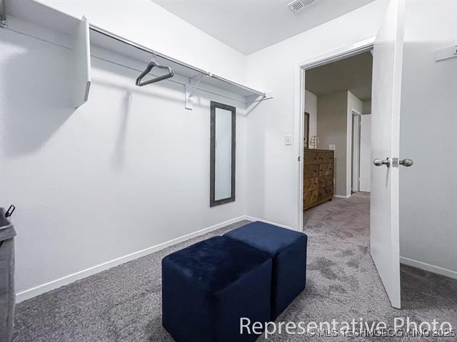 8508 E Queens St, Broken Arrow, OK 74014 - walk in closet featuring carpet