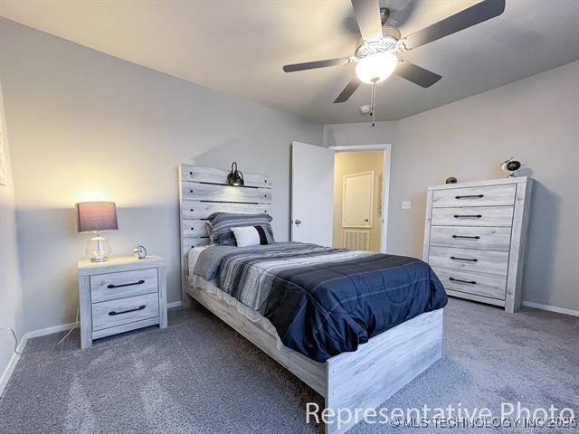 8508 E Queens St, Broken Arrow, OK 74014 - bedroom with carpet floors, baseboards, and a ceiling fan