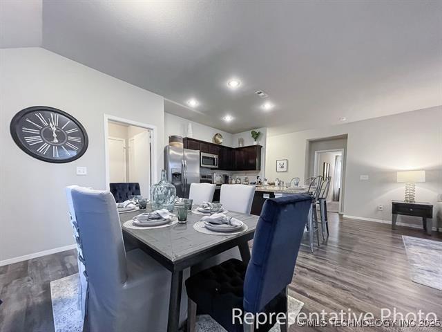8508 E Queens St, Broken Arrow, OK 74014 - dining space featuring dark wood-type flooring, baseboards, lofted ceiling, and recessed lighting
