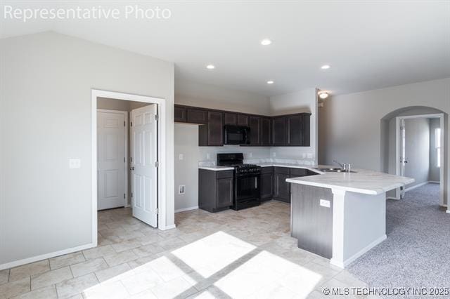 8508 E Queens St, Broken Arrow, OK 74014 - kitchen with black appliances, arched walkways, light countertops, baseboards, and recessed lighting