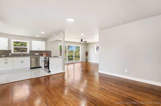 5939 E 26th St, Tulsa, OK 74114 - kitchen with stainless steel appliances, tasteful backsplash, ceiling fan, open floor plan, and plenty of natural light