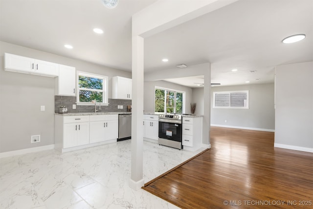 5939 E 26th St, Tulsa, OK 74114 - kitchen featuring stainless steel appliances, baseboards, white cabinetry, backsplash, and recessed lighting