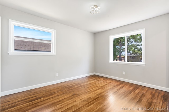 5939 E 26th St, Tulsa, OK 74114 - empty room featuring wood finished floors and baseboards