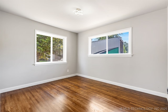 5939 E 26th St, Tulsa, OK 74114 - unfurnished room featuring healthy amount of natural light, baseboards, and wood finished floors