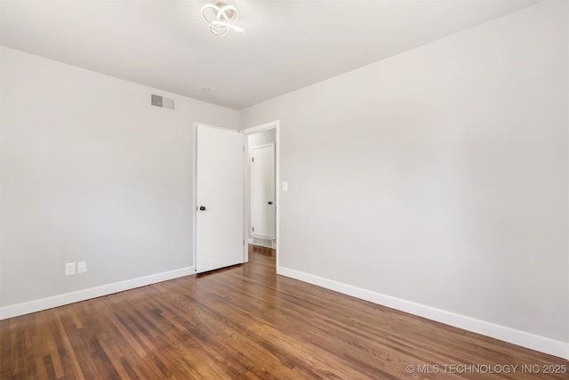 5939 E 26th St, Tulsa, OK 74114 - spare room featuring baseboards and wood finished floors