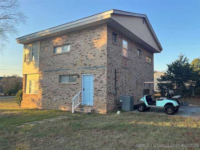 114227 S 4172nd Rd, Checotah, OK 74426 - view of property exterior featuring entry steps, brick siding, and a yard