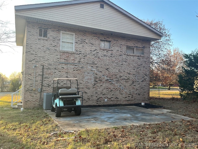 114227 S 4172nd Rd, Checotah, OK 74426 - view of side of home with brick siding, central AC, and a patio area