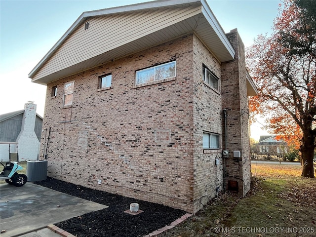 114227 S 4172nd Rd, Checotah, OK 74426 - view of home's exterior with brick siding, central AC, and a patio area