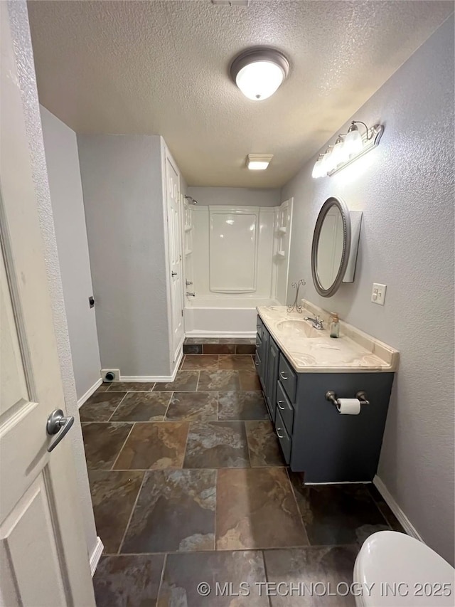 114227 S 4172nd Rd, Checotah, OK 74426 - bathroom featuring a textured ceiling, baseboards, double vanity, stone tile floors, and shower / bathtub combination