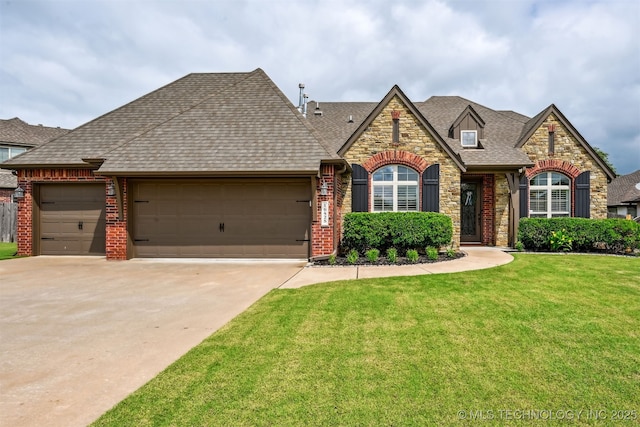 16425 E 49th St, Tulsa, OK 74134 - french country home with an attached garage, a front yard, stone siding, driveway, and roof with shingles