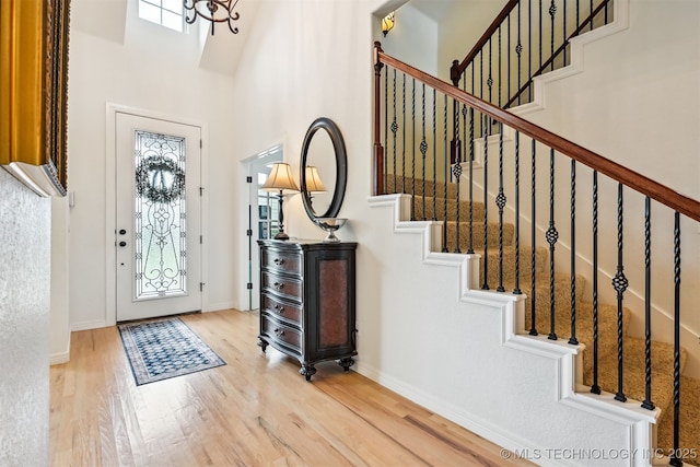 16425 E 49th St, Tulsa, OK 74134 - foyer featuring wood finished floors, a high ceiling, stairs, and baseboards